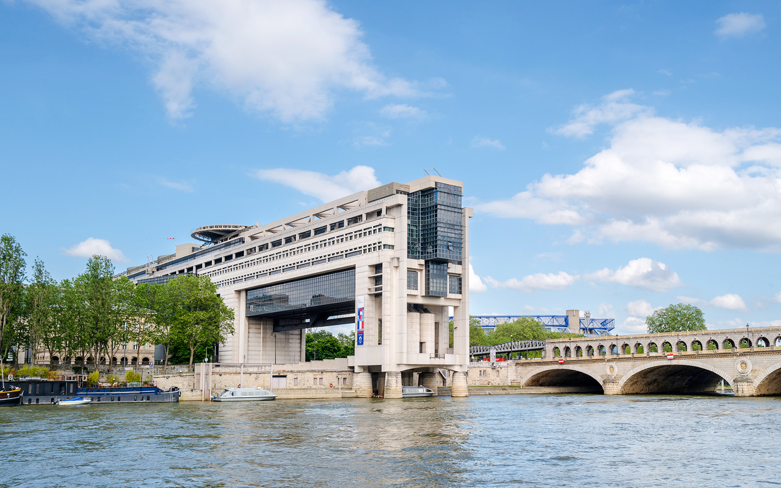 Bercy Bridge and Ministry of Economy building viewed from Seine River Cruise, Paris.
