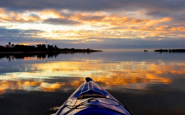 Kayak on calm water at sunset during a Dubai tour.