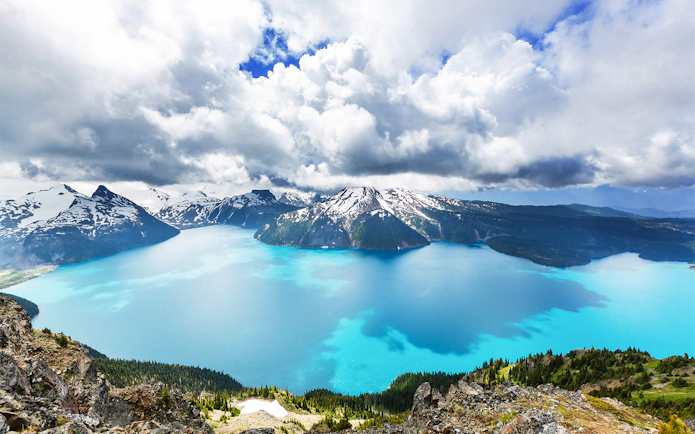 Scenic aerial view of Garibaldi Lake with surrounding snow-capped mountains during Whistler Glacier seaplane tour.
