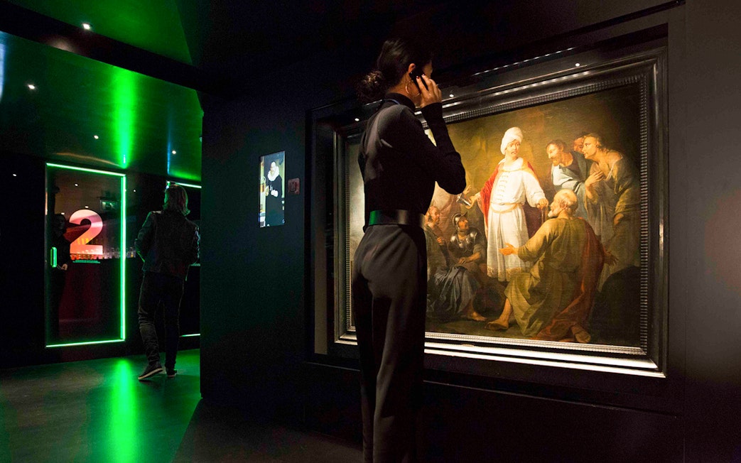 Visitor viewing artwork at Moco Museum, Amsterdam.