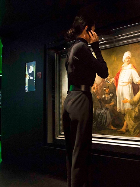 Visitor viewing artwork at Moco Museum, Amsterdam.