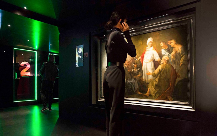 Visitor viewing artwork at Moco Museum, Amsterdam.