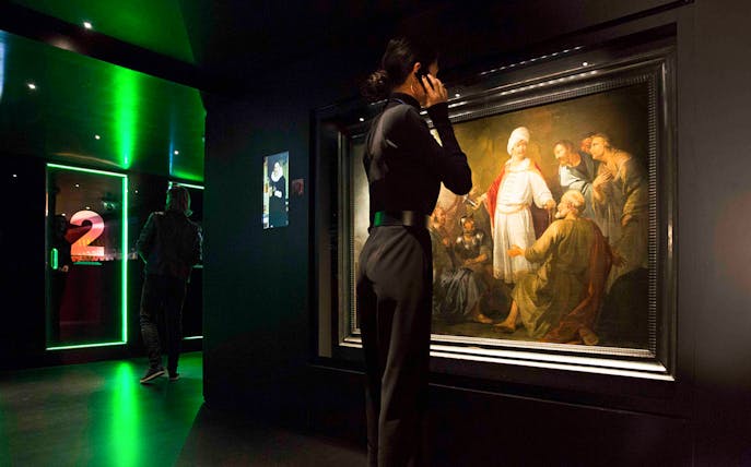 Visitor viewing artwork at Moco Museum, Amsterdam.