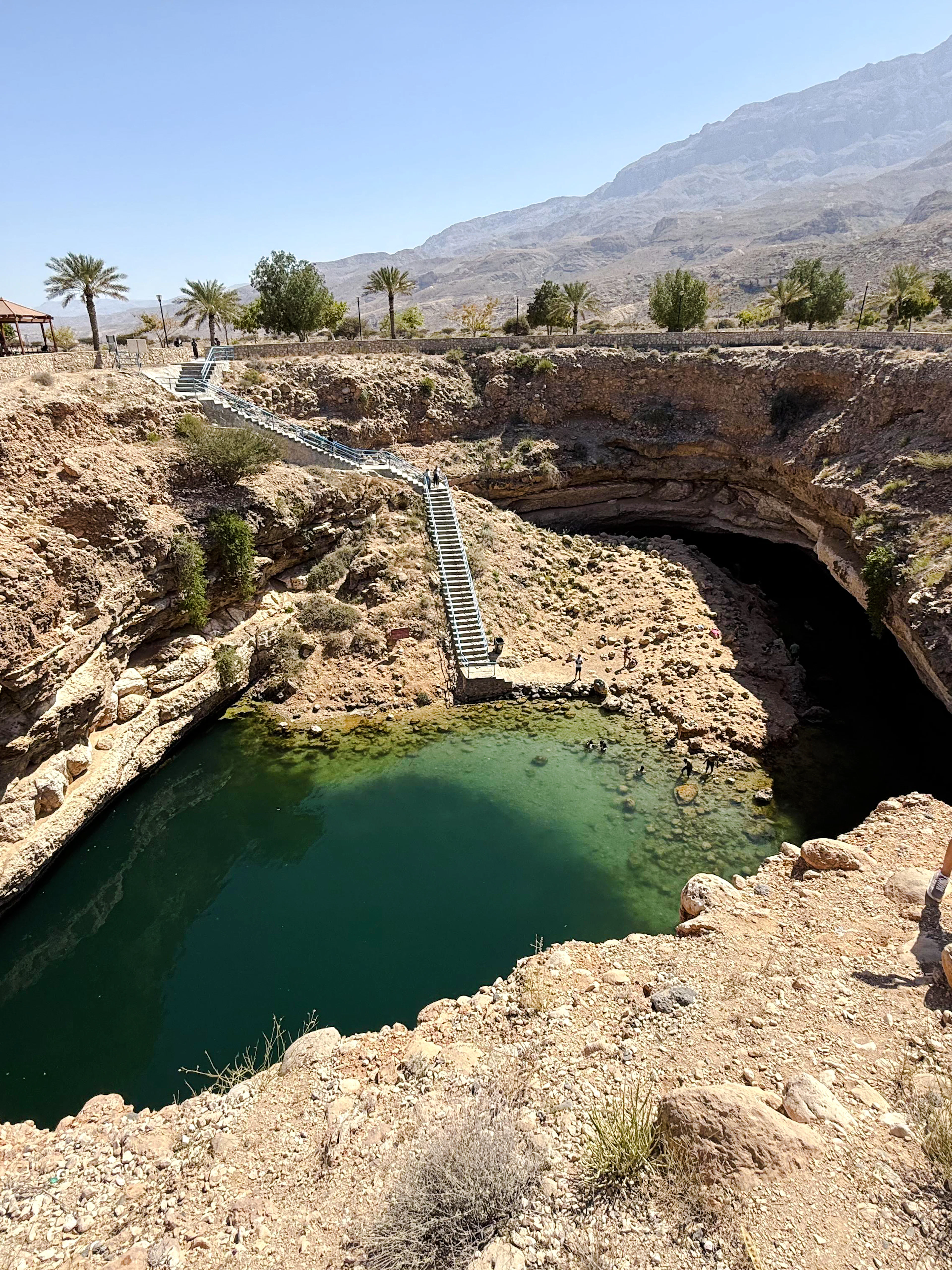 Wadi Shab and Bimmah Sinkhole with stairs and visitor, Muscat tour.