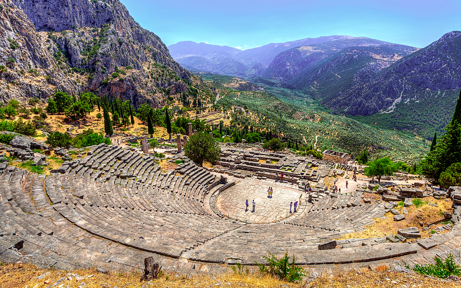 Ancient Theater in Delphi with mountainous landscape in the background.