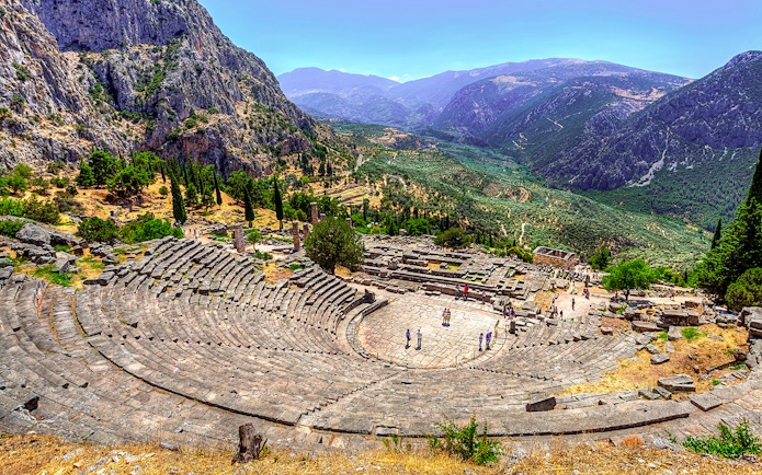 Ancient Theater in Delphi with mountainous landscape in the background.