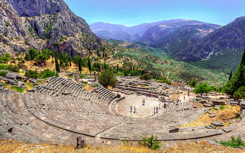 Ancient Theater in Delphi with mountainous landscape in the background.