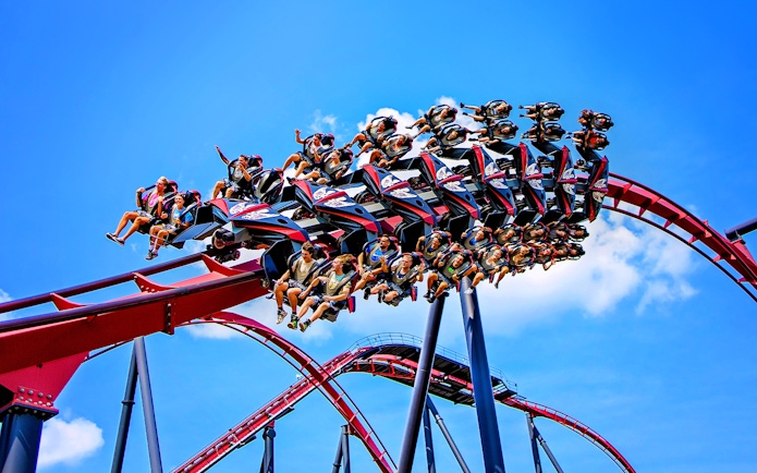 Riders on X Flight roller coaster at Six Flags Great America.