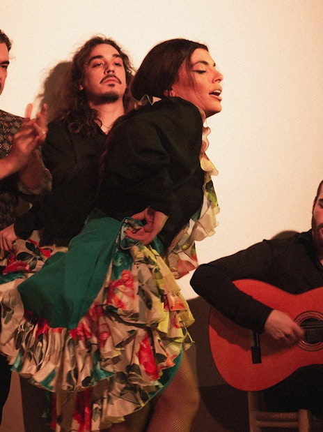Flamenco dancers and guitarist performing at a tablao in Madrid.