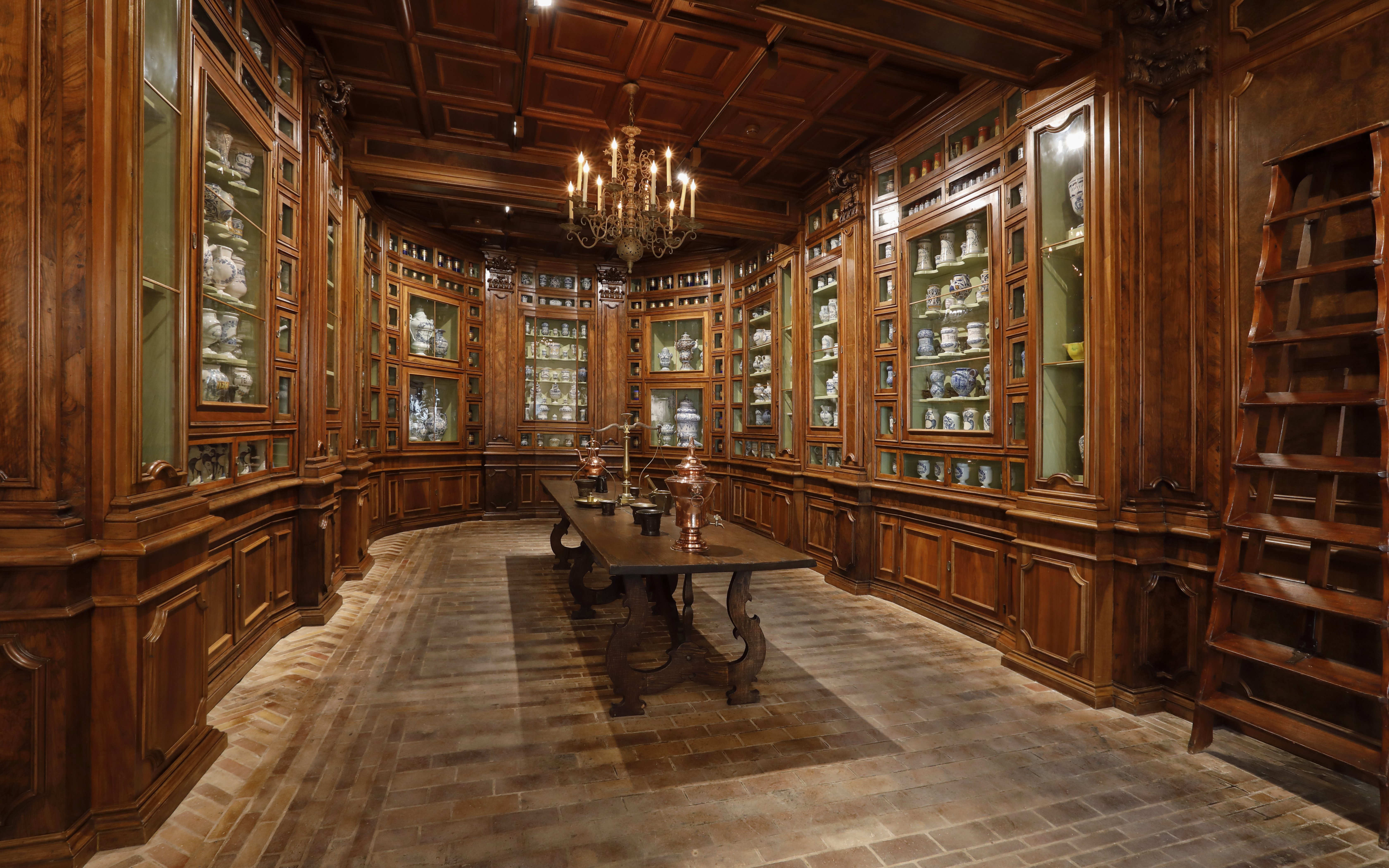 Chenonceau Castle interior with wooden cabinets displaying porcelain collections.