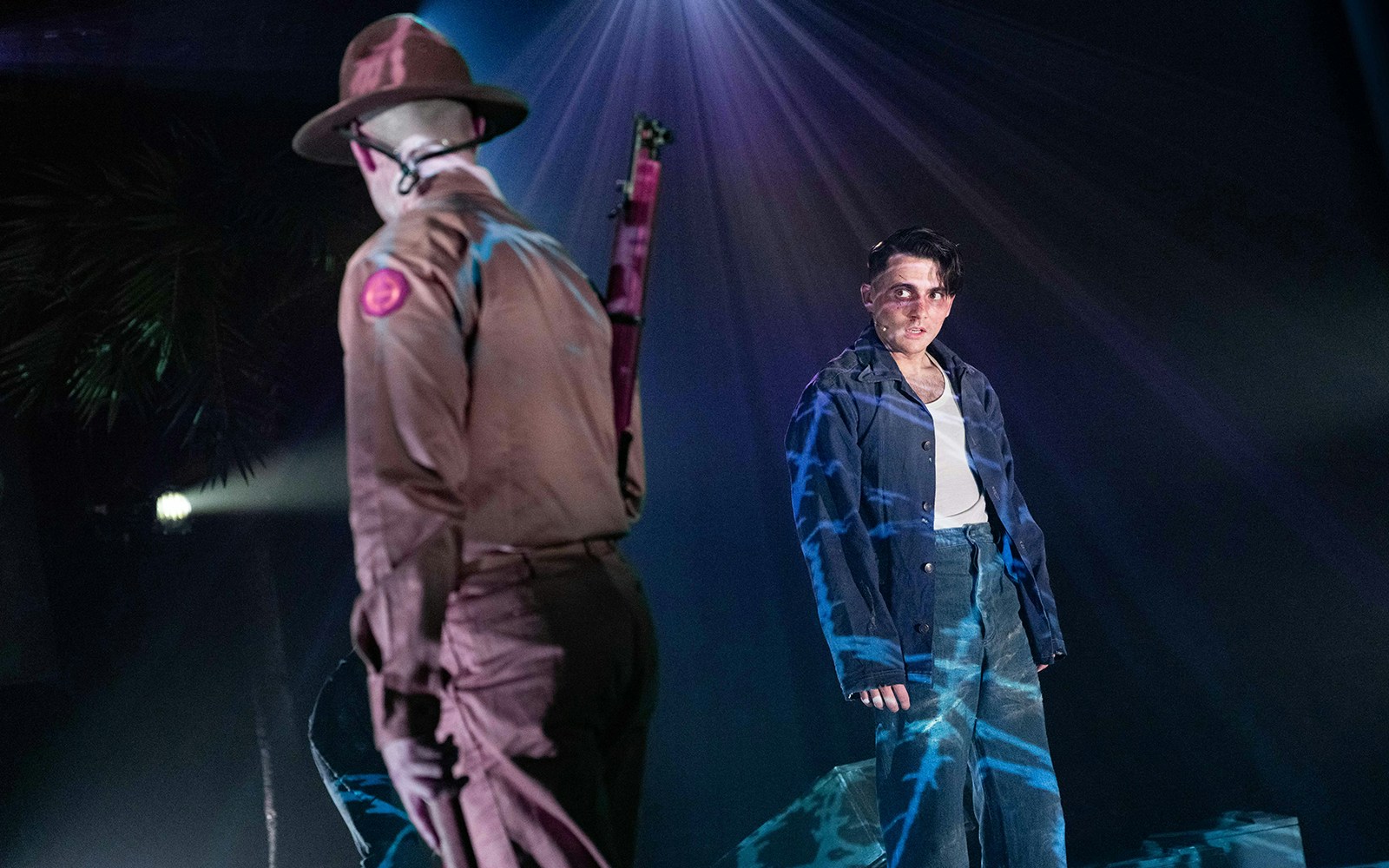 Soldier confronts a man on stage in "From Here To Eternity – The Musical" scene.