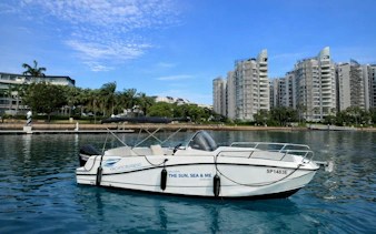 Speedboat docked at Marina with cityscape backdrop, YachtCruiseSG tour.
