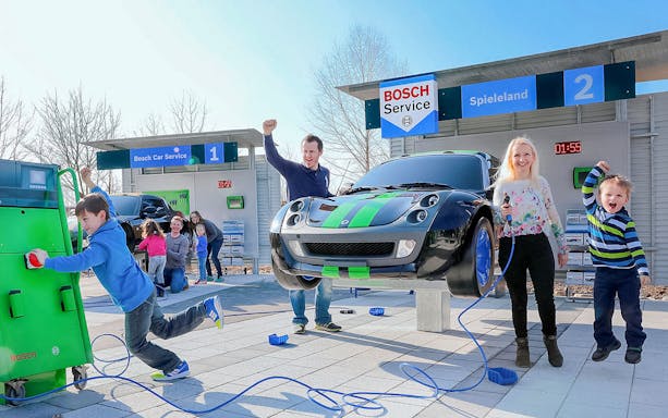Children and adults enjoying interactive car-themed attraction at Ravensburger Spieleland.