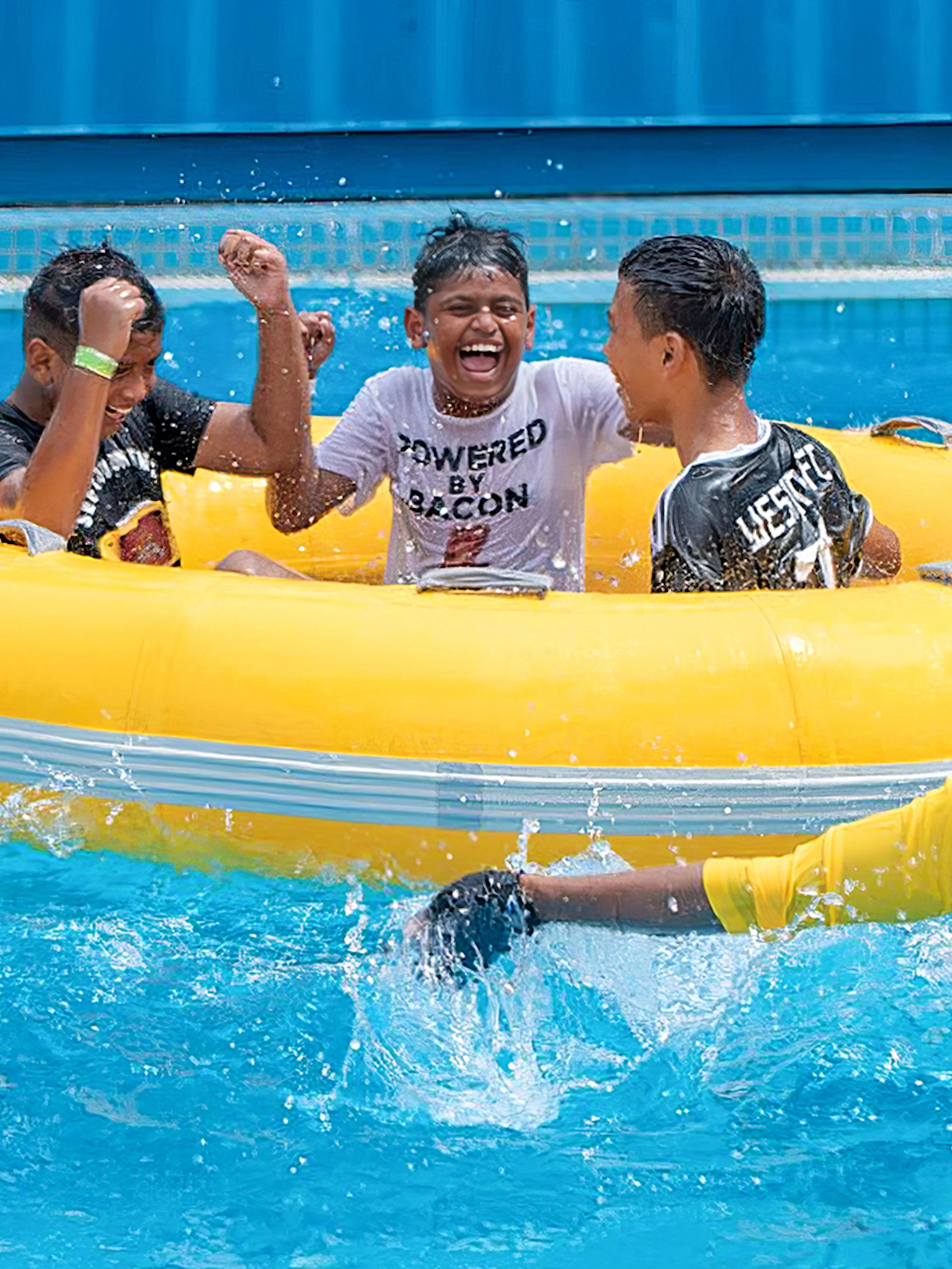 Group enjoying a yellow raft ride at Splash Out Langkawi Water Theme Park.