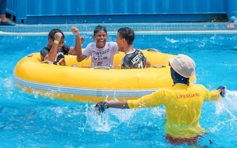 Group enjoying a yellow raft ride at Splash Out Langkawi Water Theme Park.