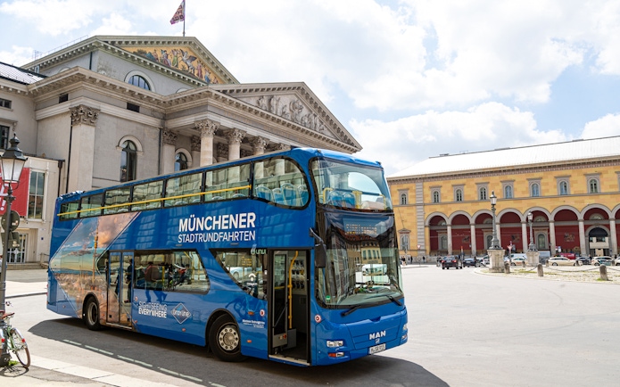 Double-decker bus in front of Munich's National Theatre on a city tour.