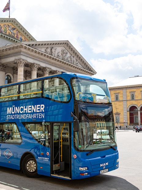 Double-decker bus in front of Munich's National Theatre on a city tour.