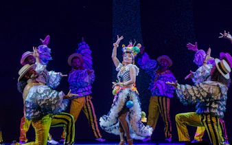 Performers in vibrant costumes dancing at the Roxy Dinner Show in Rio de Janeiro.