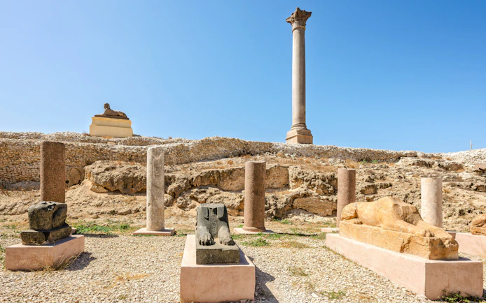 Ancient Roman column and Egyptian sphinxes at Pompey's Pillar site, Alexandria, Egypt.