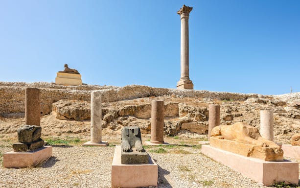 Ancient Roman column and Egyptian sphinxes at Pompey's Pillar site, Alexandria, Egypt.