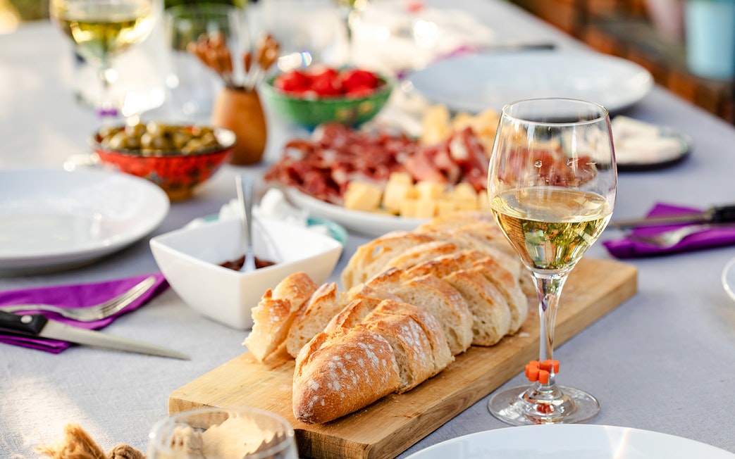 Wine and charcuterie spread on a table in Paris, France.