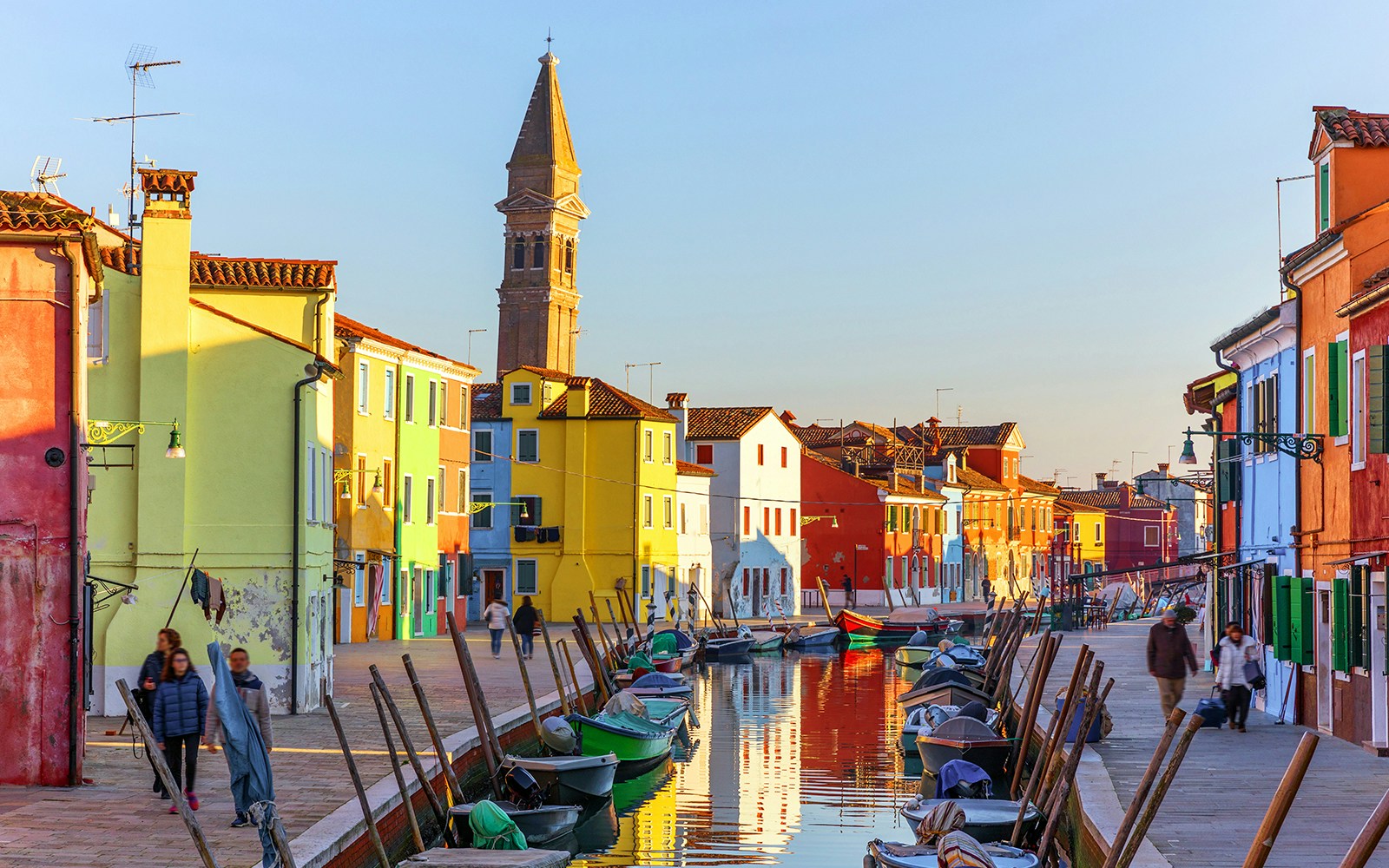 Burano Island colorful houses along canal with boats, Venice day tour.