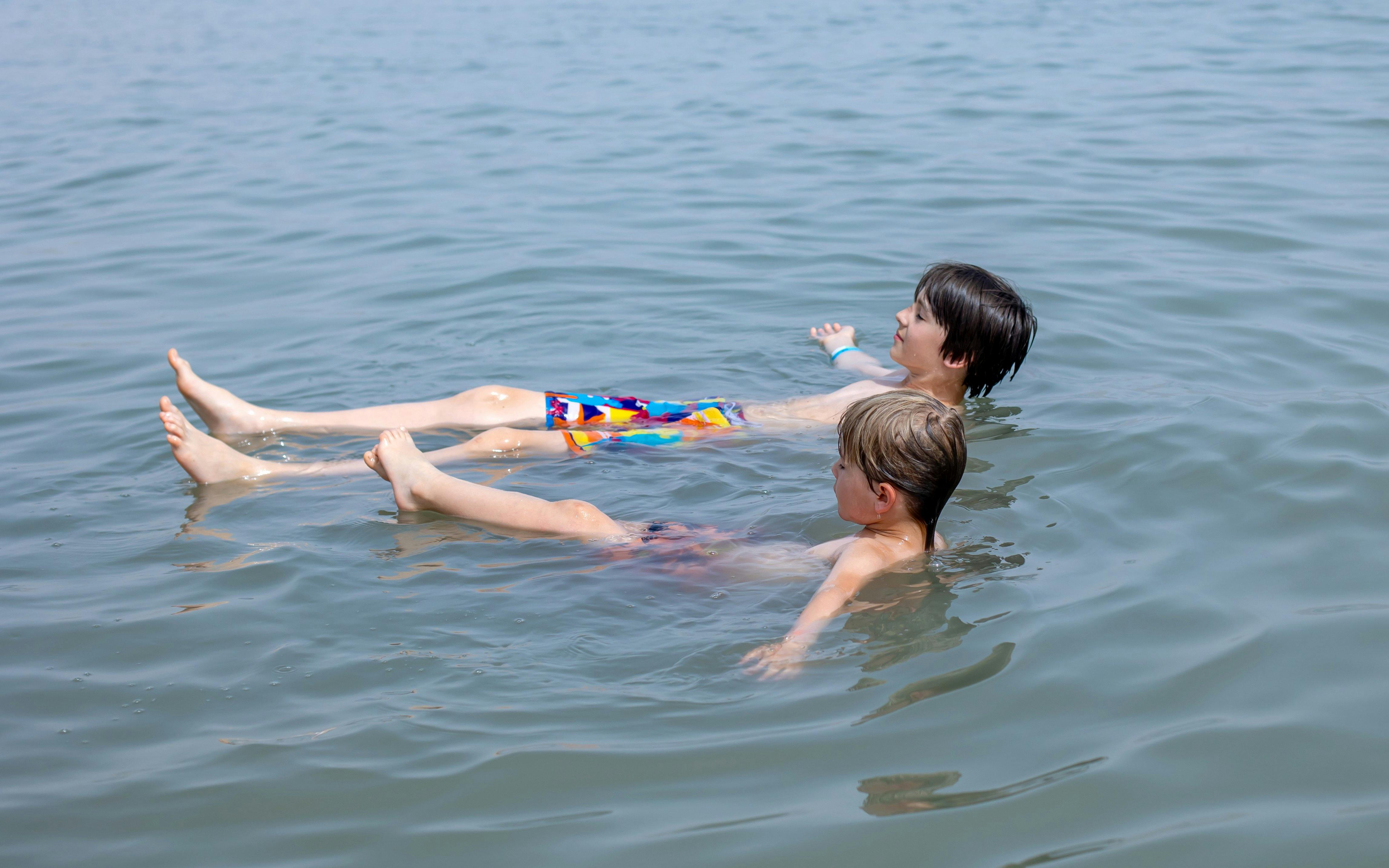 Children floating in the Dead Sea, Israel.