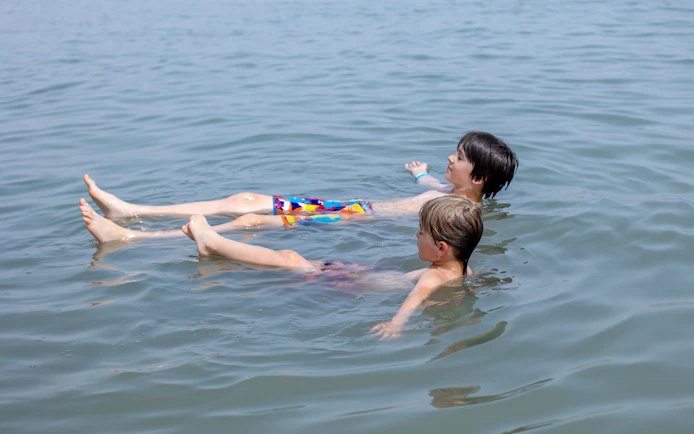 Children floating in the Dead Sea, Israel.