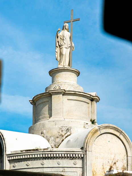 Tomb with statue and cross in St. Louis Cemetery, New Orleans.