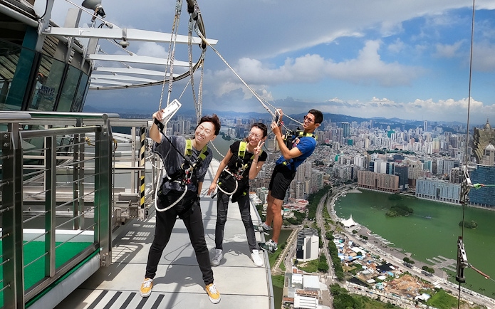 Visitors enjoying the Skypark Macau by AJ Hackett with cityscape view.