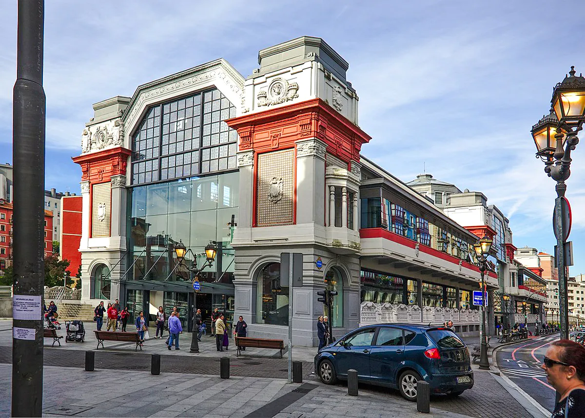 Bilbao's Ribera Market exterior with people walking, part of San Sebastian tour.