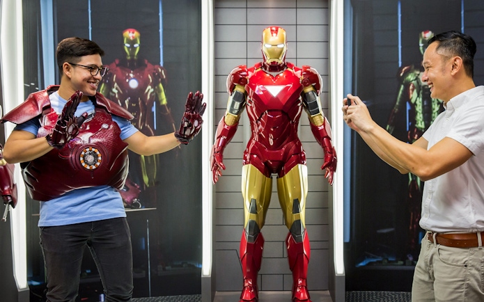 Visitor posing with Iron Man figure at Madame Tussauds Singapore.