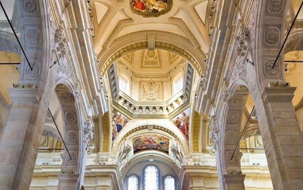 Interior view of ornate arches and frescoes in Cagliari's underground tour site.