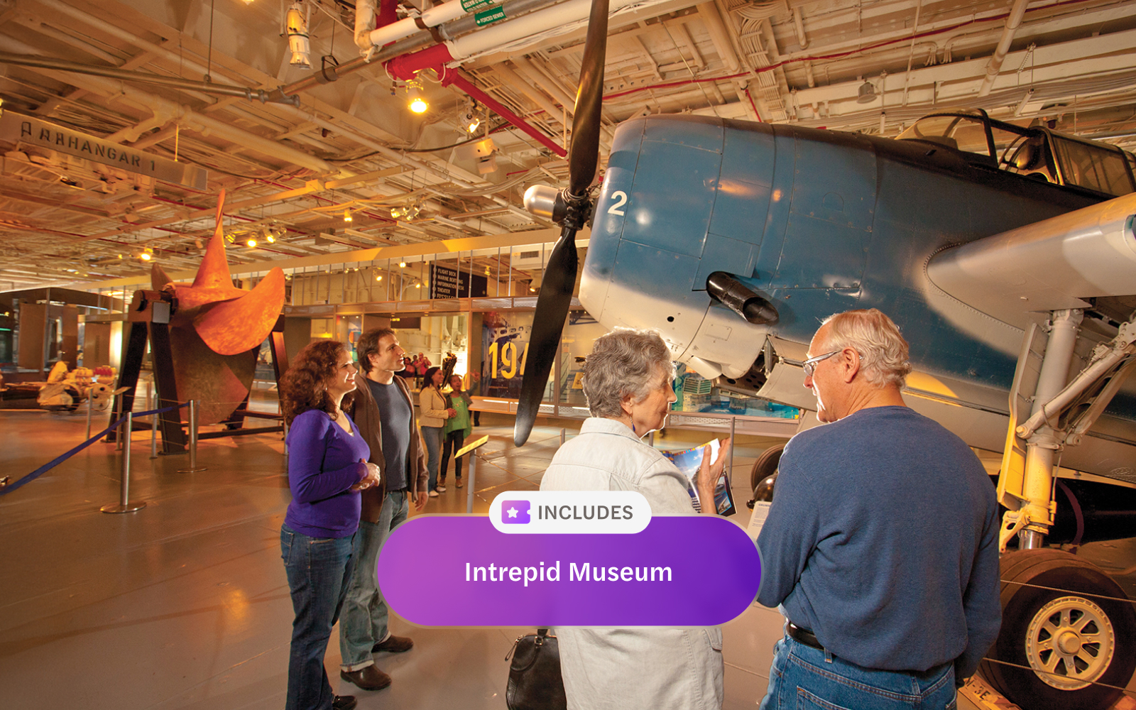 Visitors exploring aircraft exhibit at Intrepid Museum, New York City.