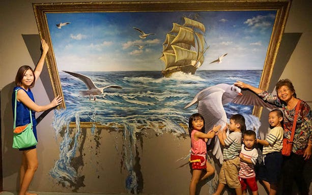 Visitors interacting with 3D ocean mural at Alive 3D Art Gallery, Port Dickson.