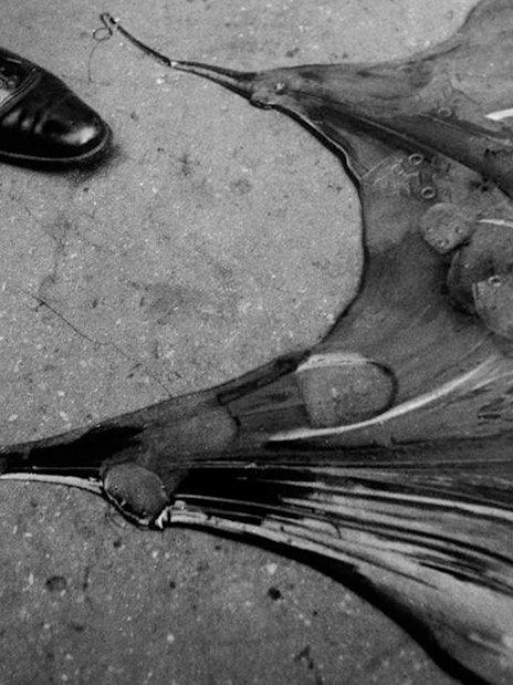 Shoes beside a broken umbrella on the ground at Lee Miller exhibition, Tate Britain.