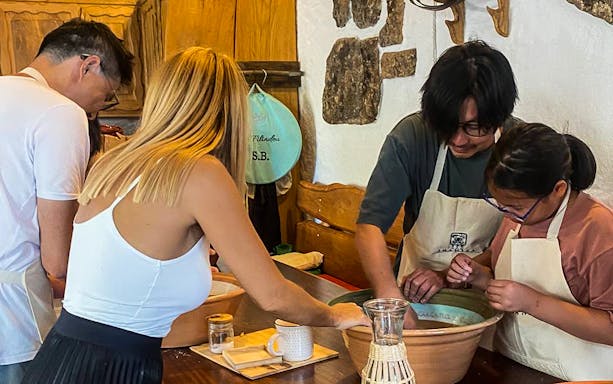 Participants making pasta in a Sardinian workshop.