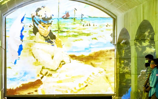 Monet painting projection at Immersivus Gallery with visitors observing.