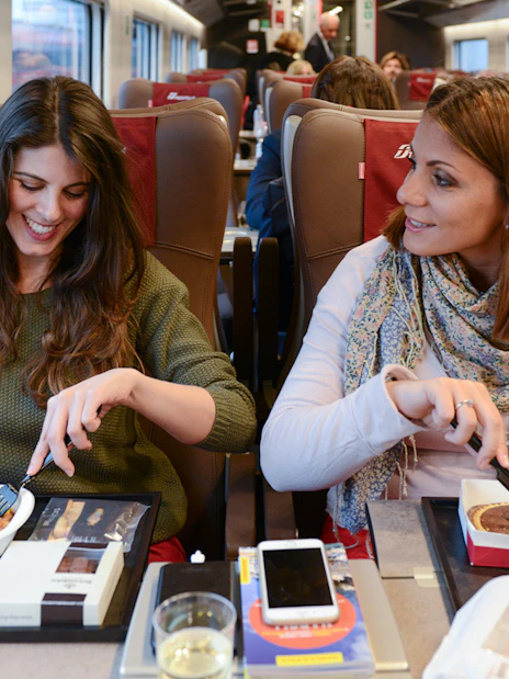 Friends dining on an Interrail train journey.