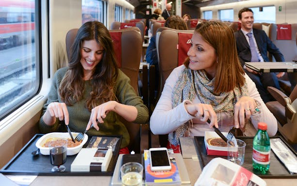 Friends dining on an Interrail train journey.