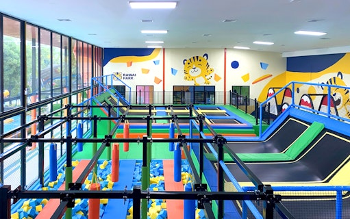 Indoor play area with trampolines and obstacle course at Rawai Kids Park.
