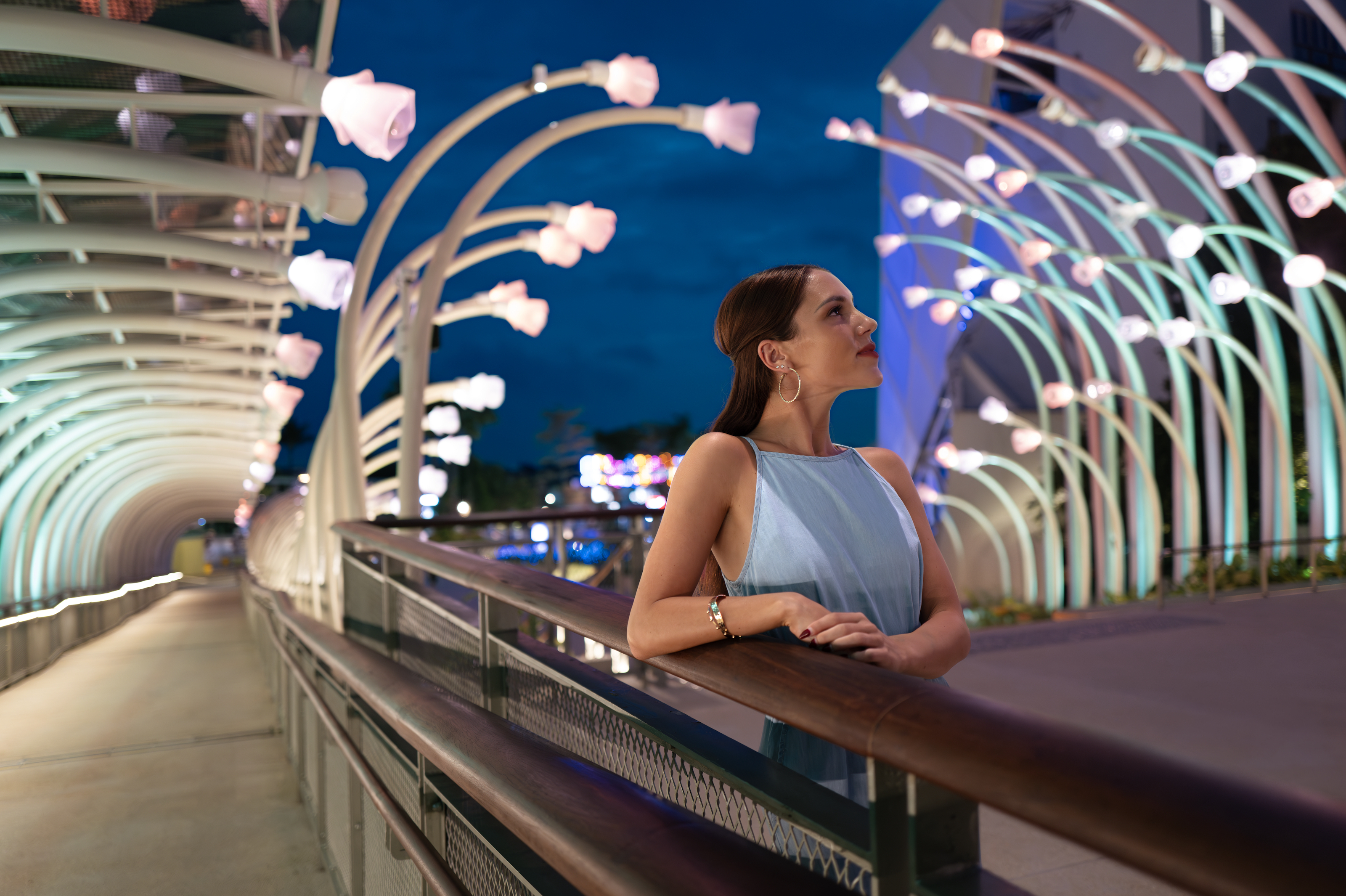Woman exploring illuminated sculptures at Resort World Sentosa's Glow Garden.