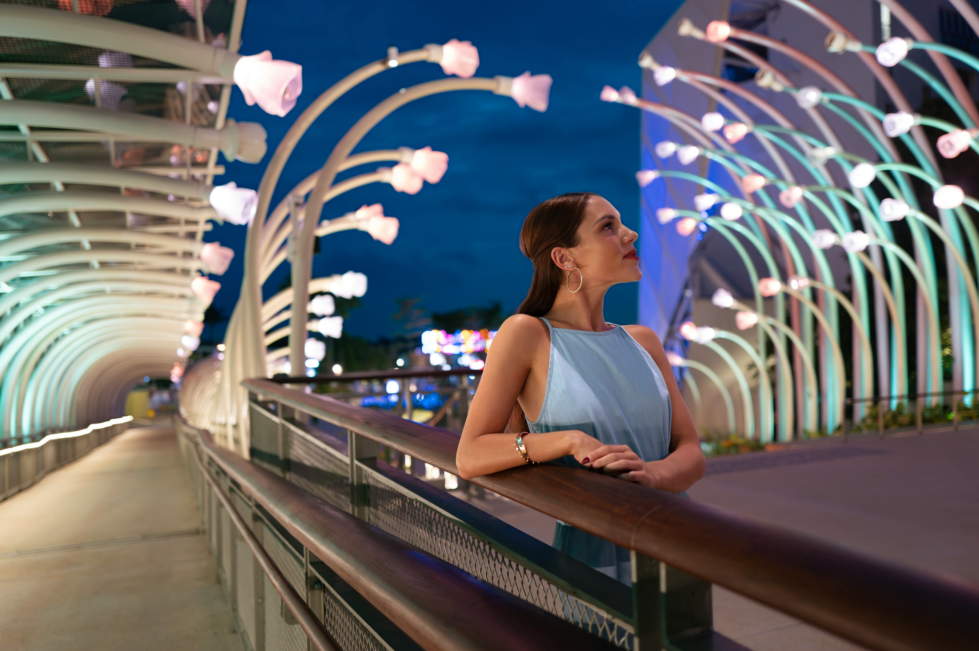 Woman exploring illuminated sculptures at Resort World Sentosa's Glow Garden.