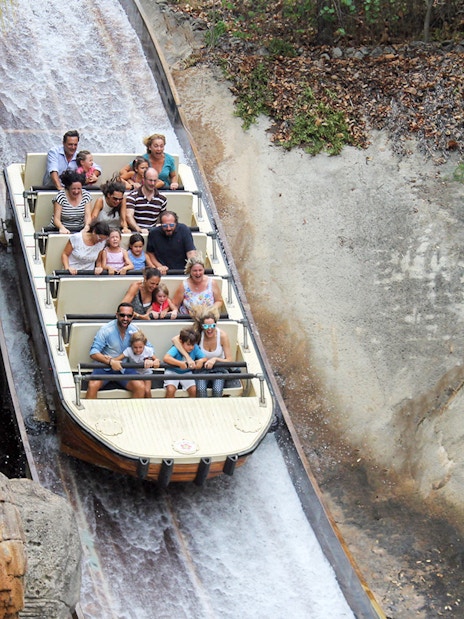 Visitors enjoying a log flume ride at Isla Mágica, Seville.