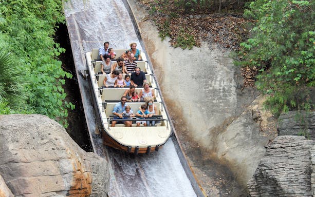 Visitors enjoying a log flume ride at Isla Mágica, Seville.