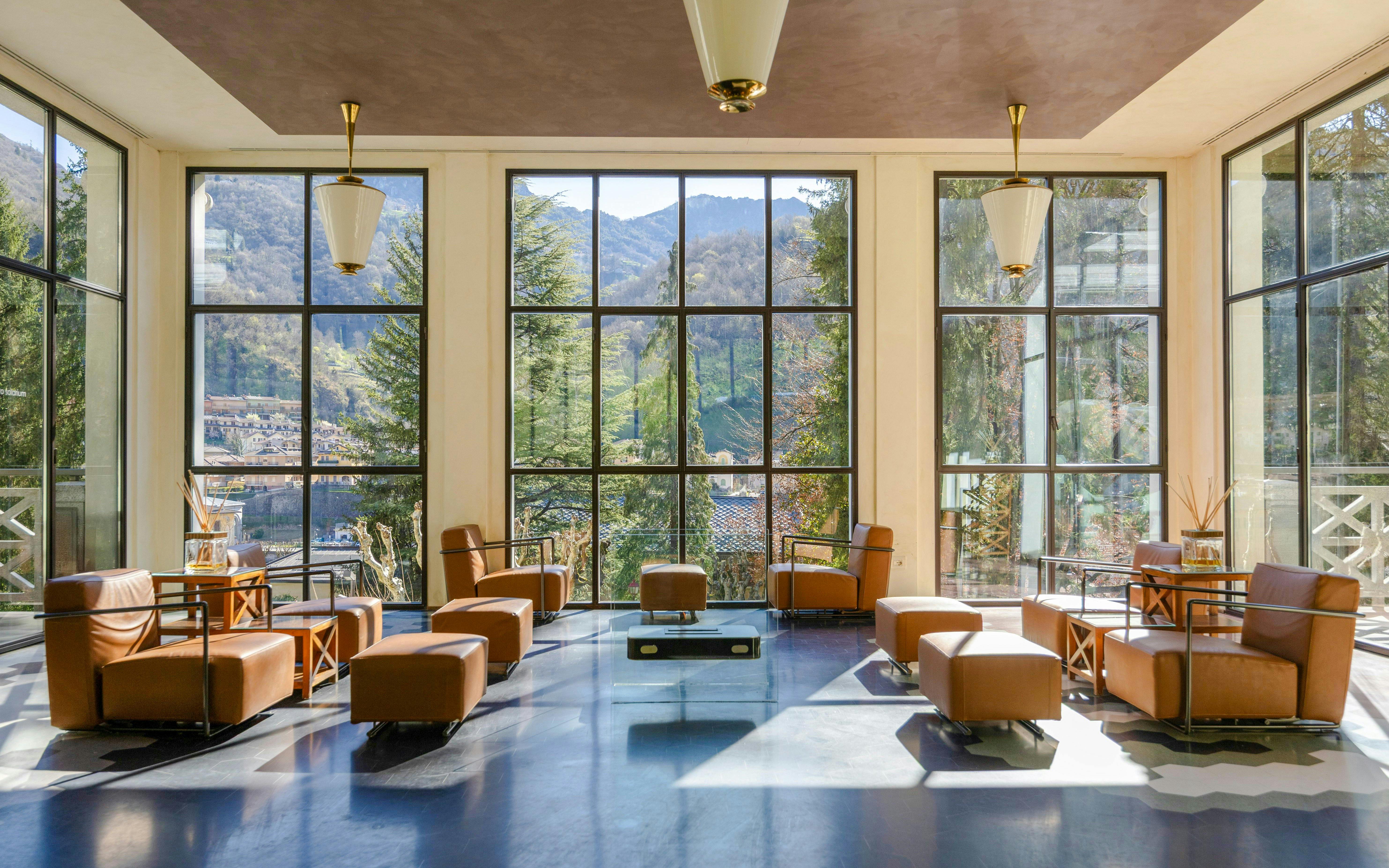 Luxurious seating area with mountain views at QC Terme San Pellegrino Spa.