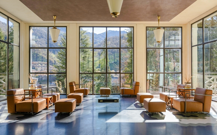 Luxurious seating area with mountain views at QC Terme San Pellegrino Spa.