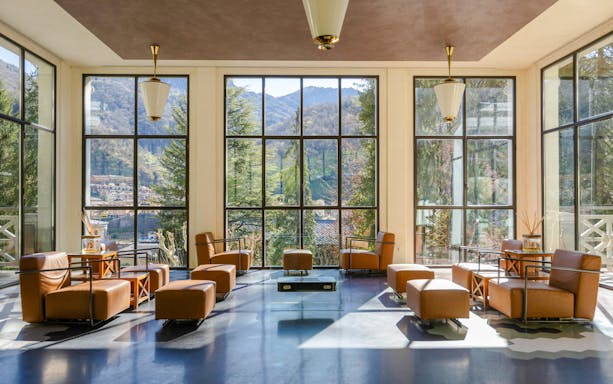 Luxurious seating area with mountain views at QC Terme San Pellegrino Spa.