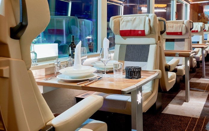 Luxurious dining setup inside Glacier Express train, Switzerland.