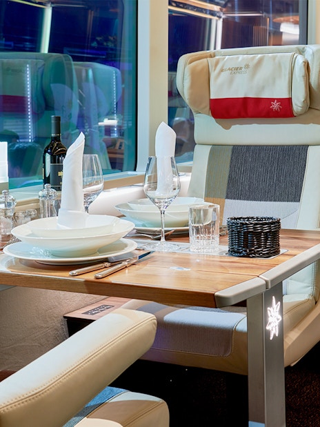 Luxurious dining setup inside Glacier Express train, Switzerland.